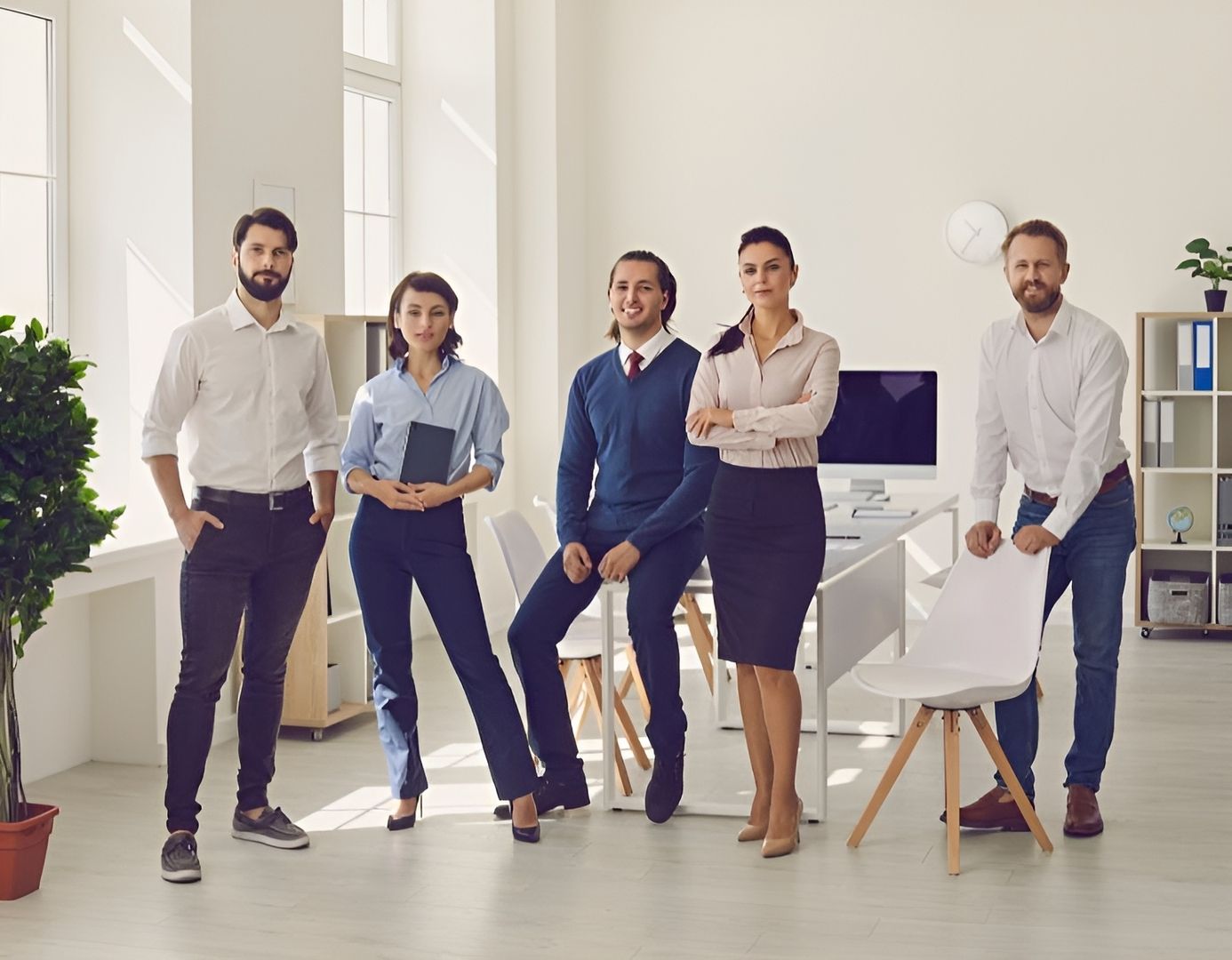 Eine Gruppe von Fachleuten steht in einem Büro und tauscht Ideen aus.